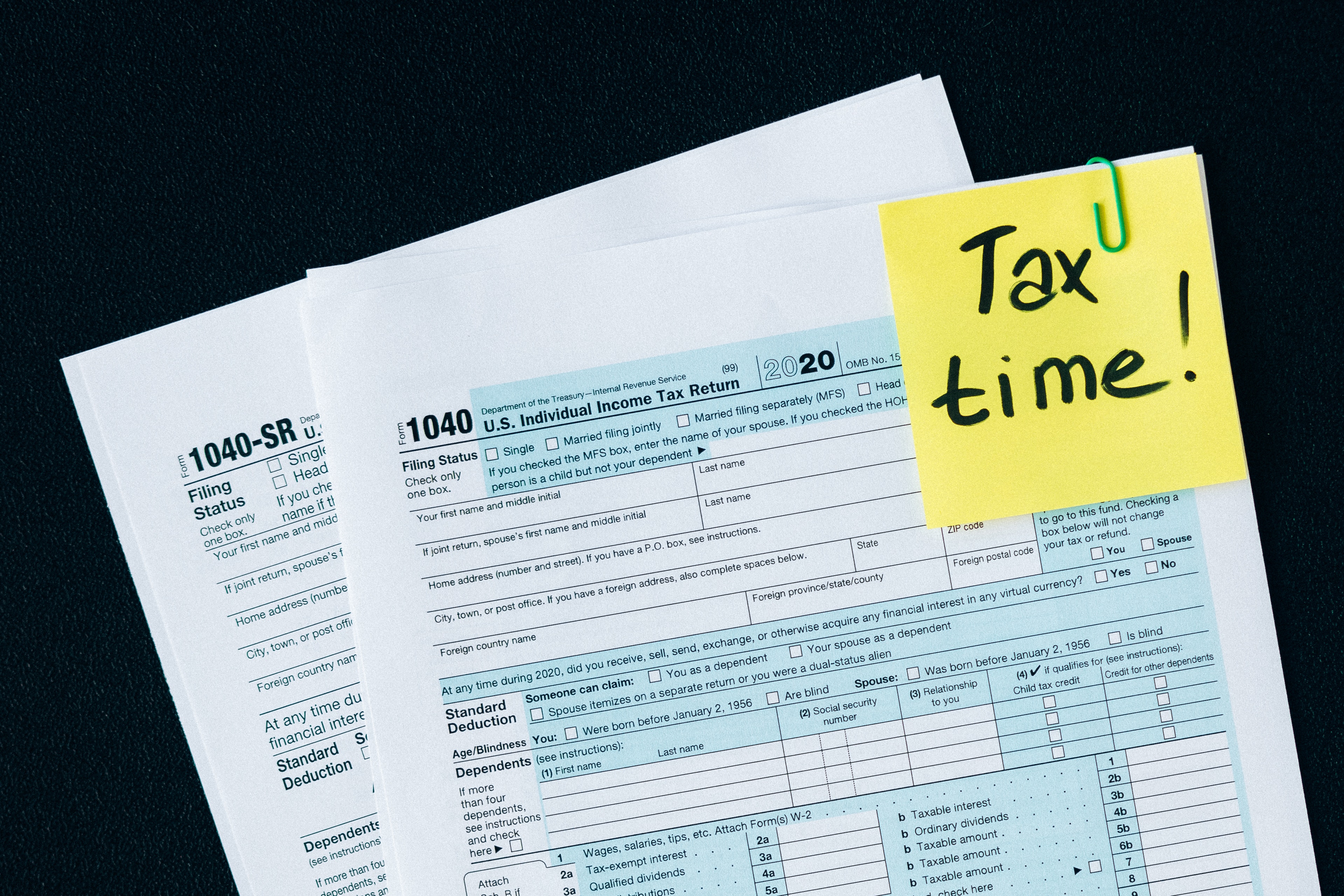 Sample of Tax documents with post it that says Tax Time